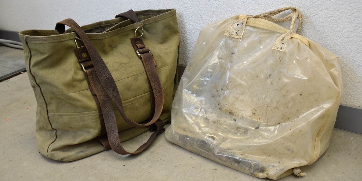 Durability of Cosmetic Bag Materials A well-used but still intact canvas bag next to a cracked PVC bag